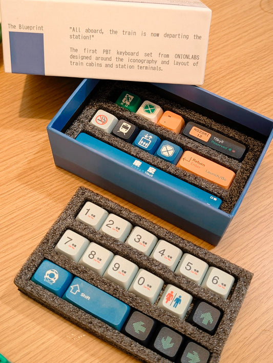 Keyboard keycaps set with a blue box on a wooden surface